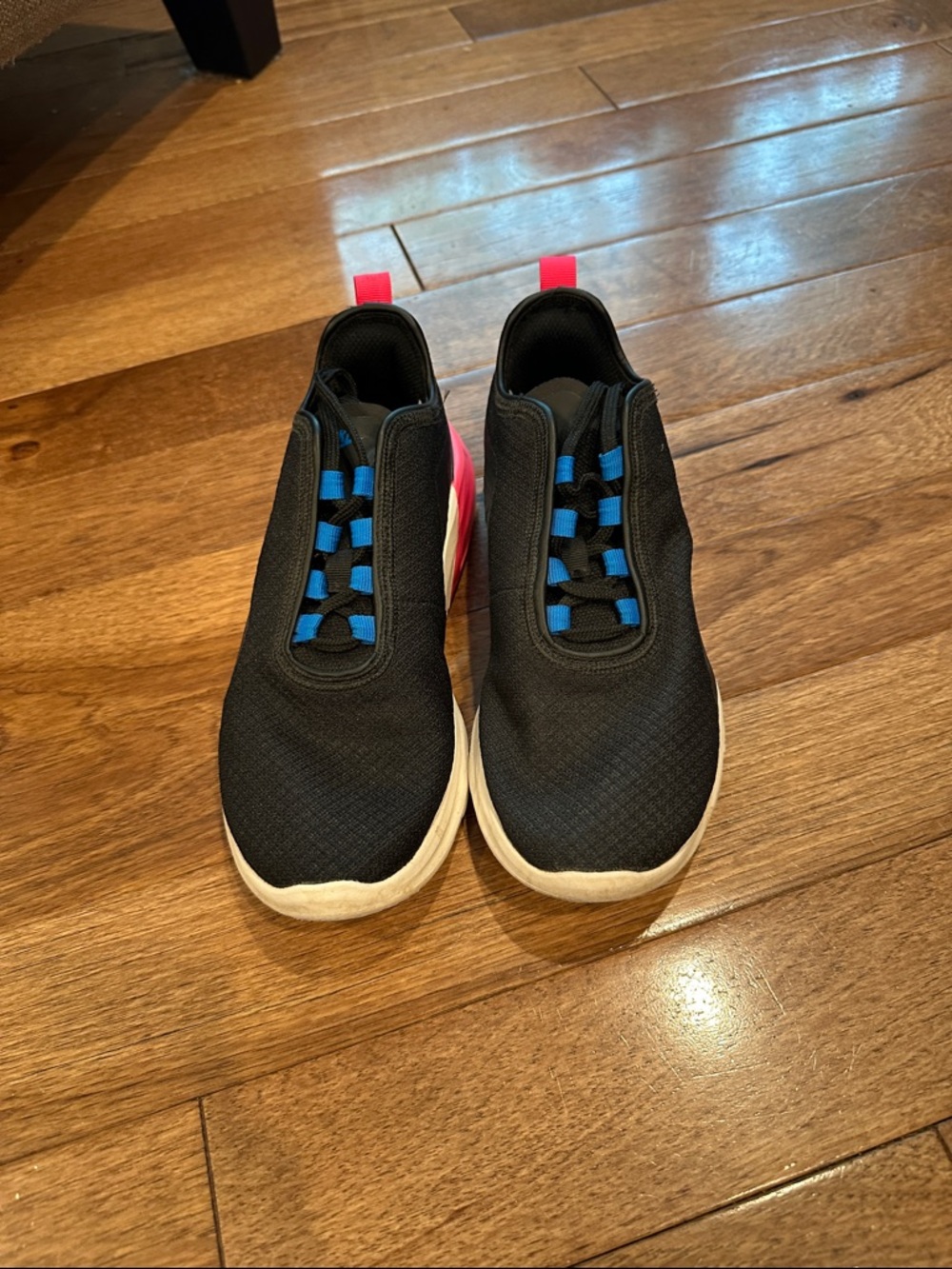 Black Nike Sneakers with Blue Accents and Pink Heel Tabs